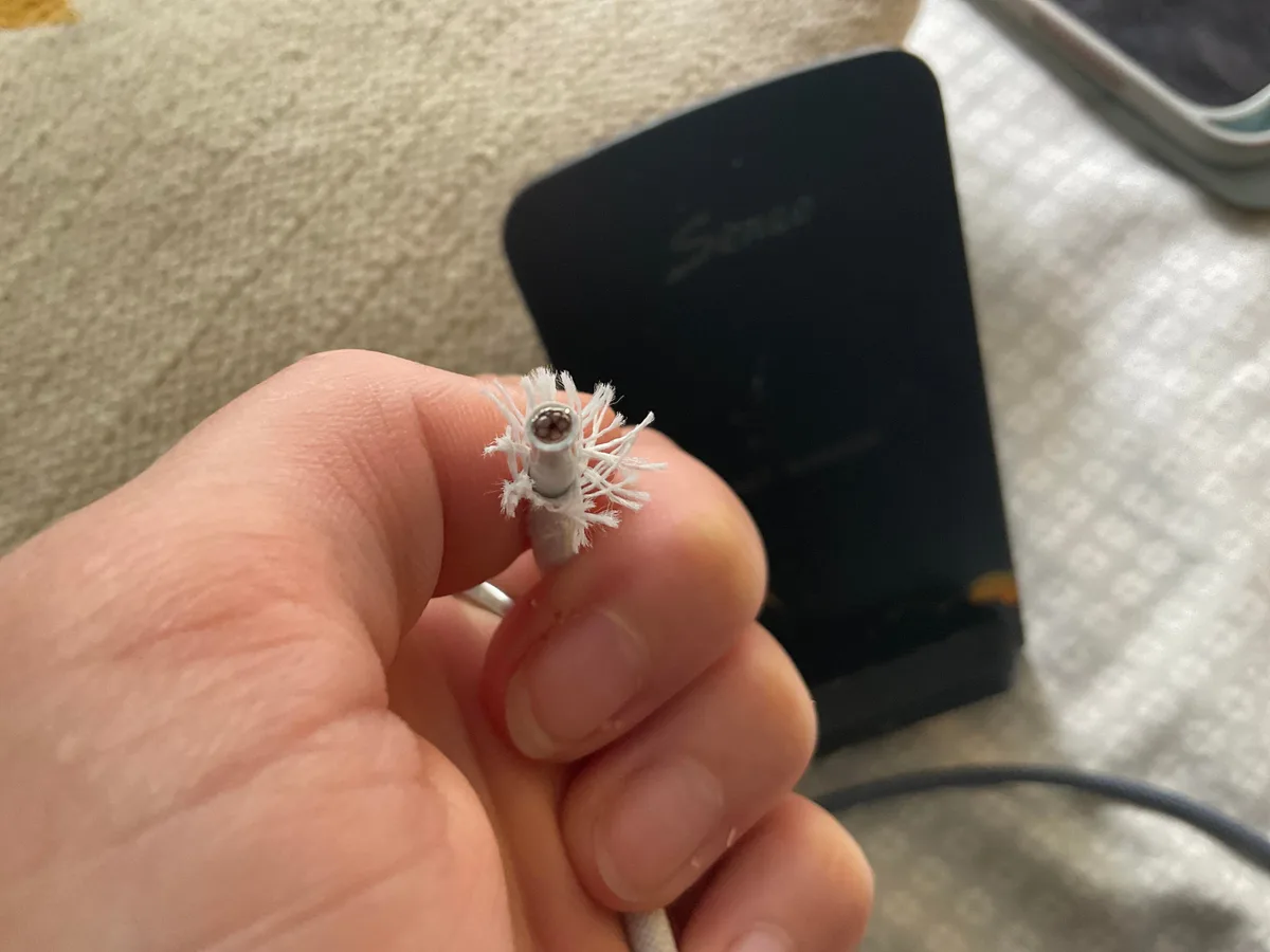 frayed MagSafe 3 cable and port lint